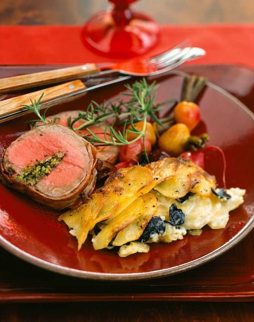 Truffled potato gratin, stuffed beef tenderloin wrapped in bacon and roasted red and yellow beets
