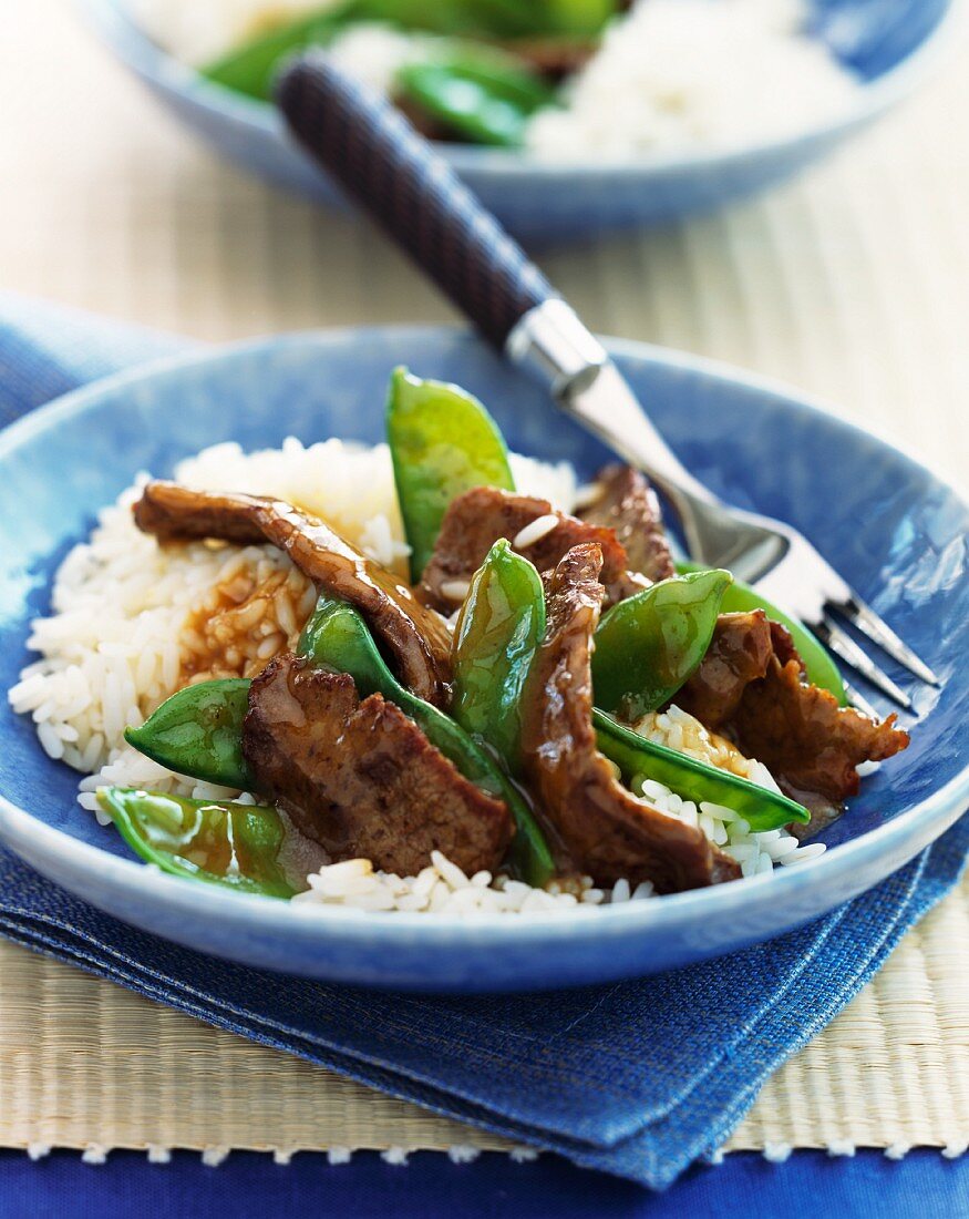 Beef and mange tout stir fry on a bed of rice