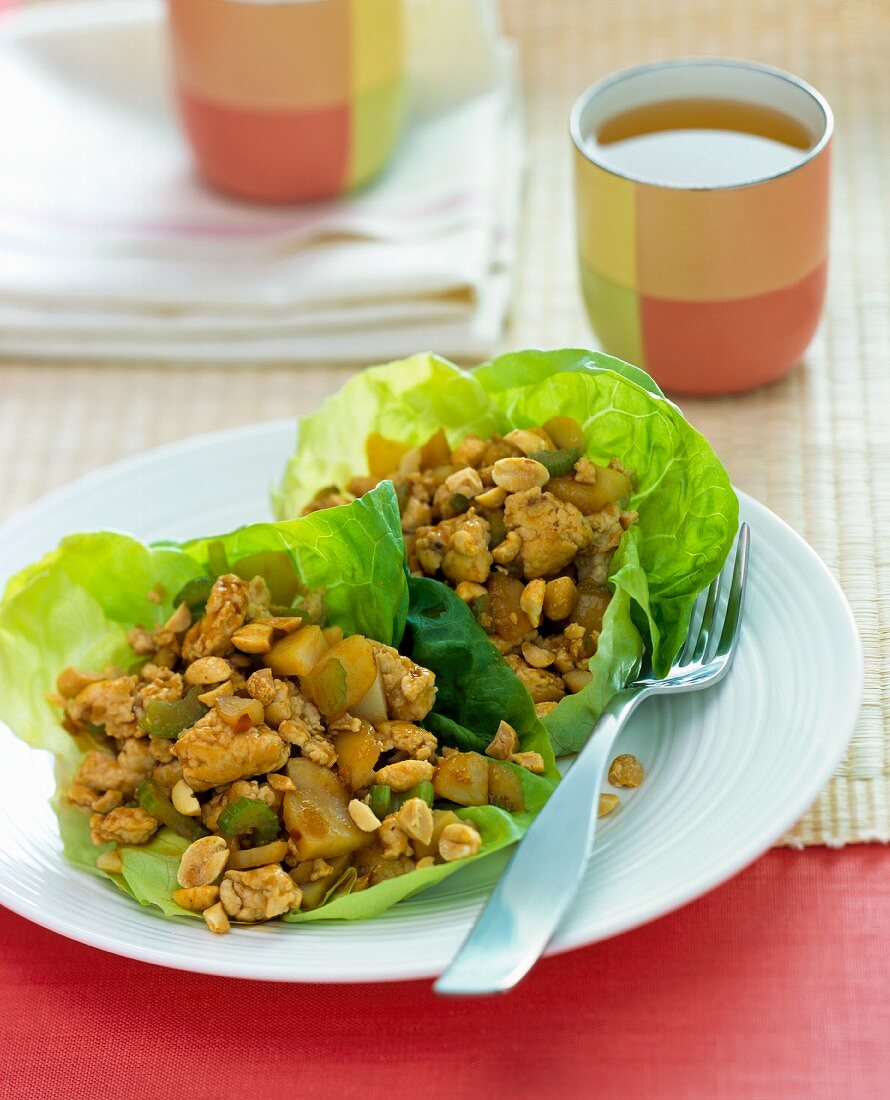 Chicken salad served in lettuce leaves with tea (China)