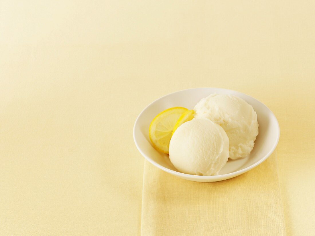 Two scoops of lemon sorbet in a bowl