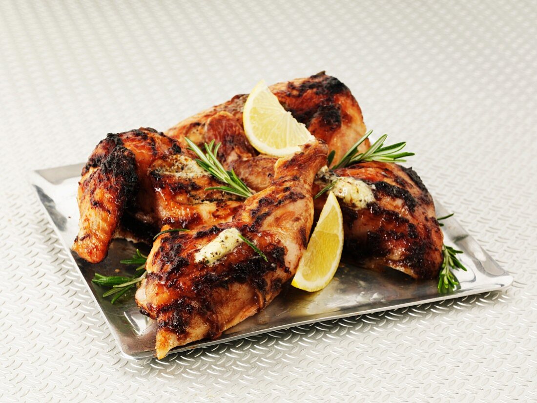 Lemon chicken with rosemary on a sliver platter