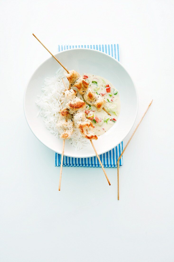 Chicken skewers with rice and wasabi sauce
