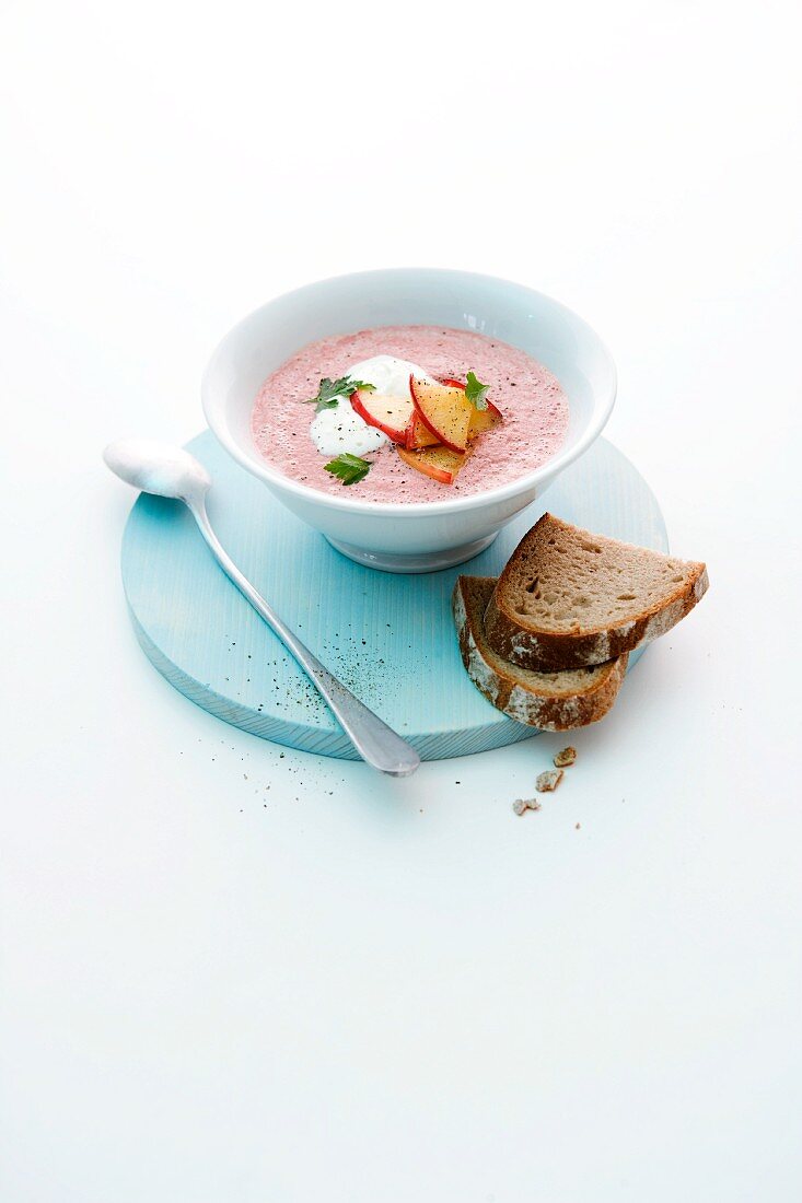 Beetroot soup with apple horseradish and slices of apple