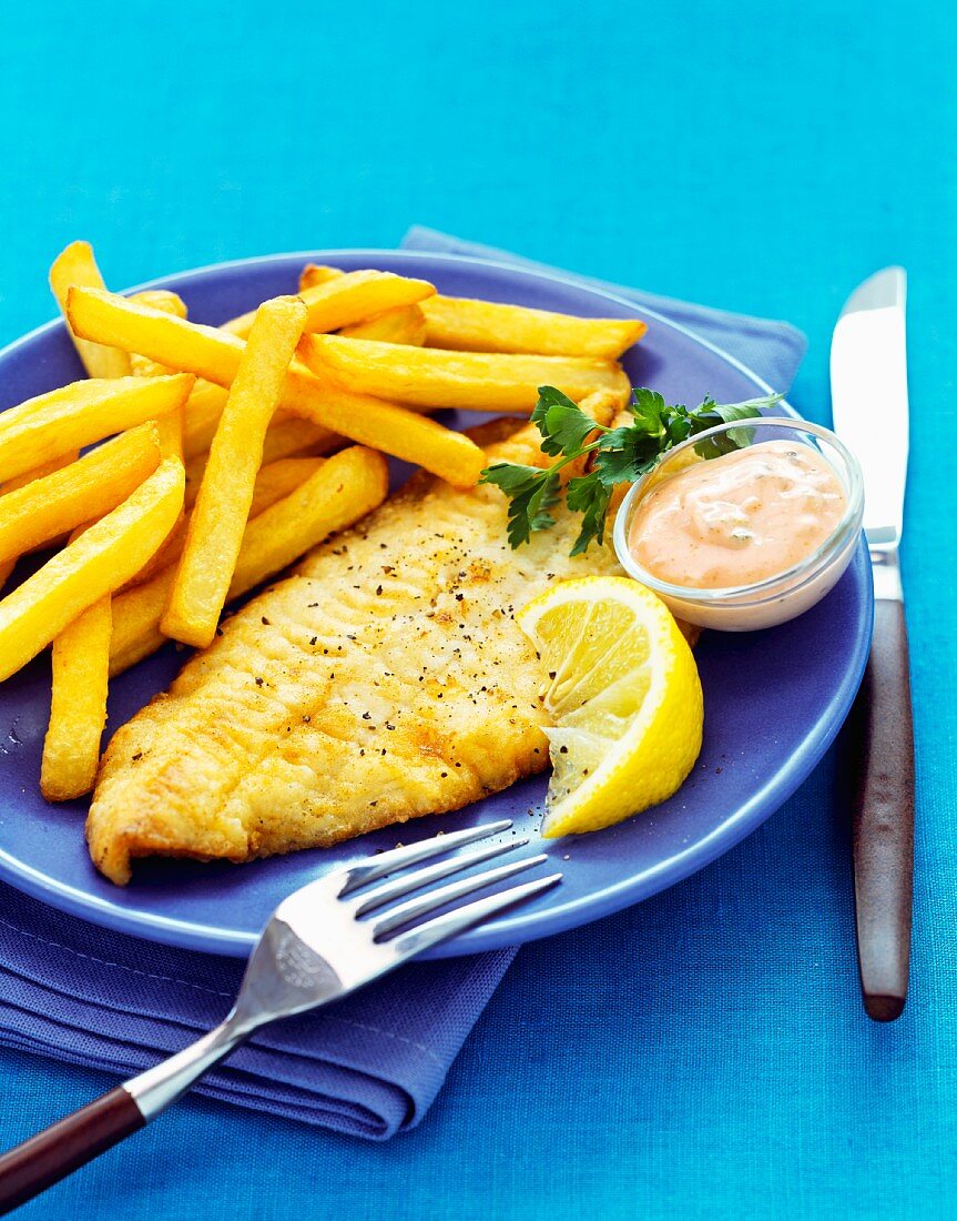 Breaded sole fillet with fries and sauce