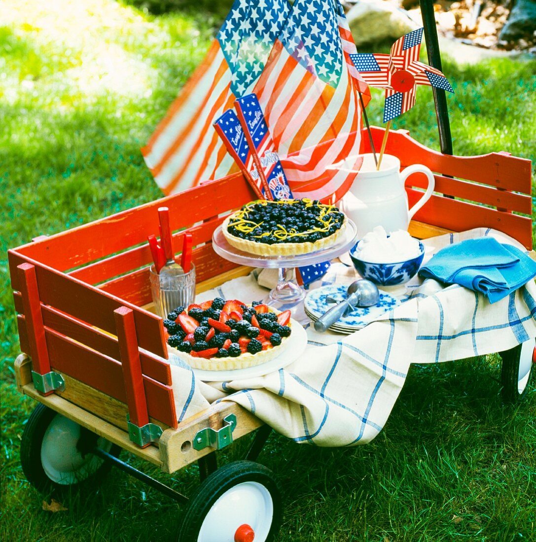 A cake buffet with a flag waving in the wind