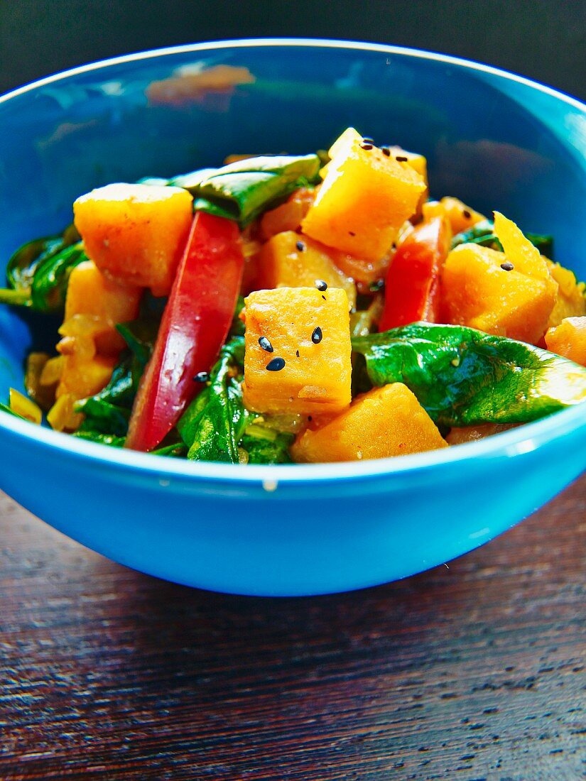 Pumpkin salad with pepper, spinach and black sesame seeds