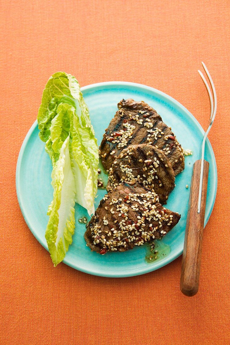 Grilled beef fillet steaks with sesame seeds