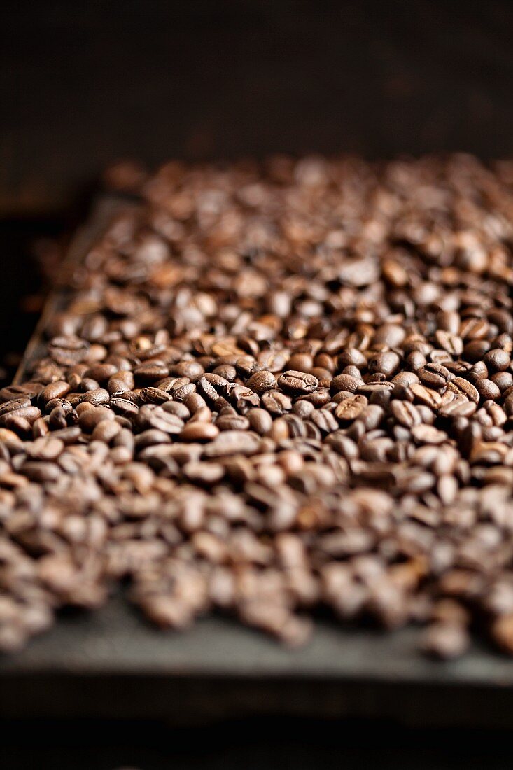 Coffee beans spread over a wooden table