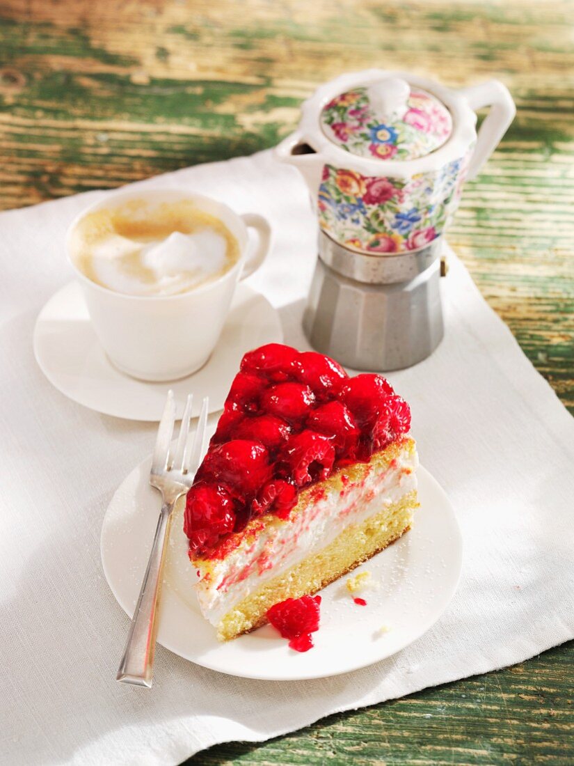 A slice of yogurt cake with raspberries served with coffee