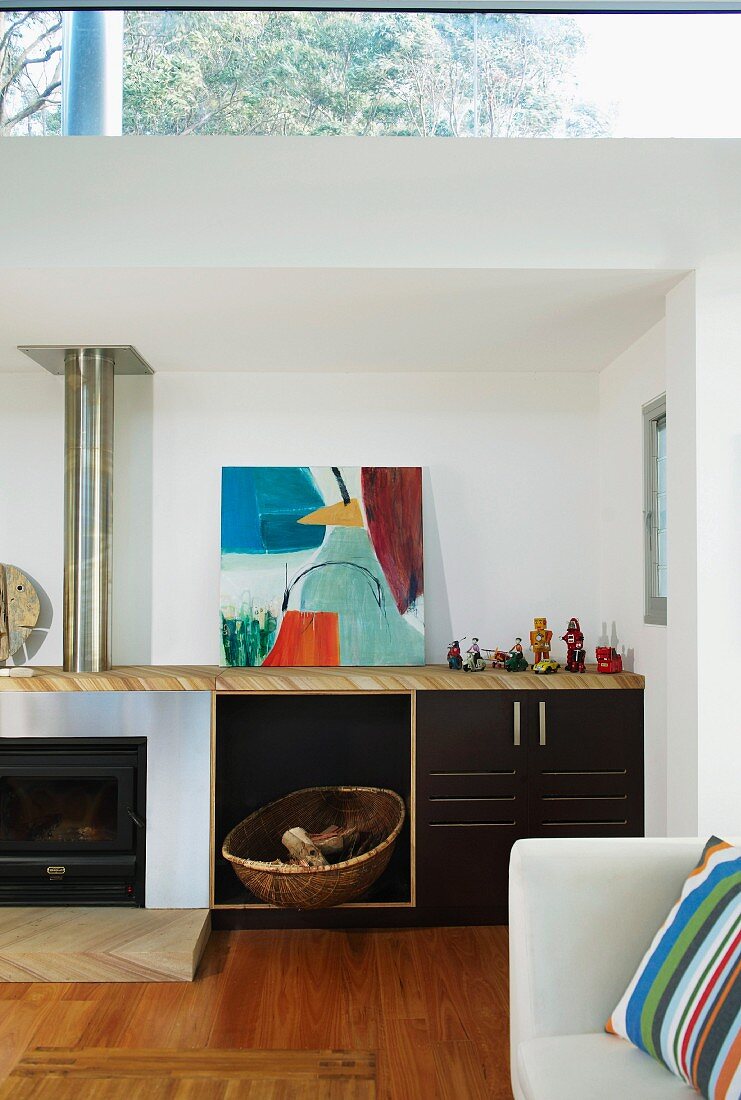 Sideboard with integrated fireplace and firewood store in modern interior