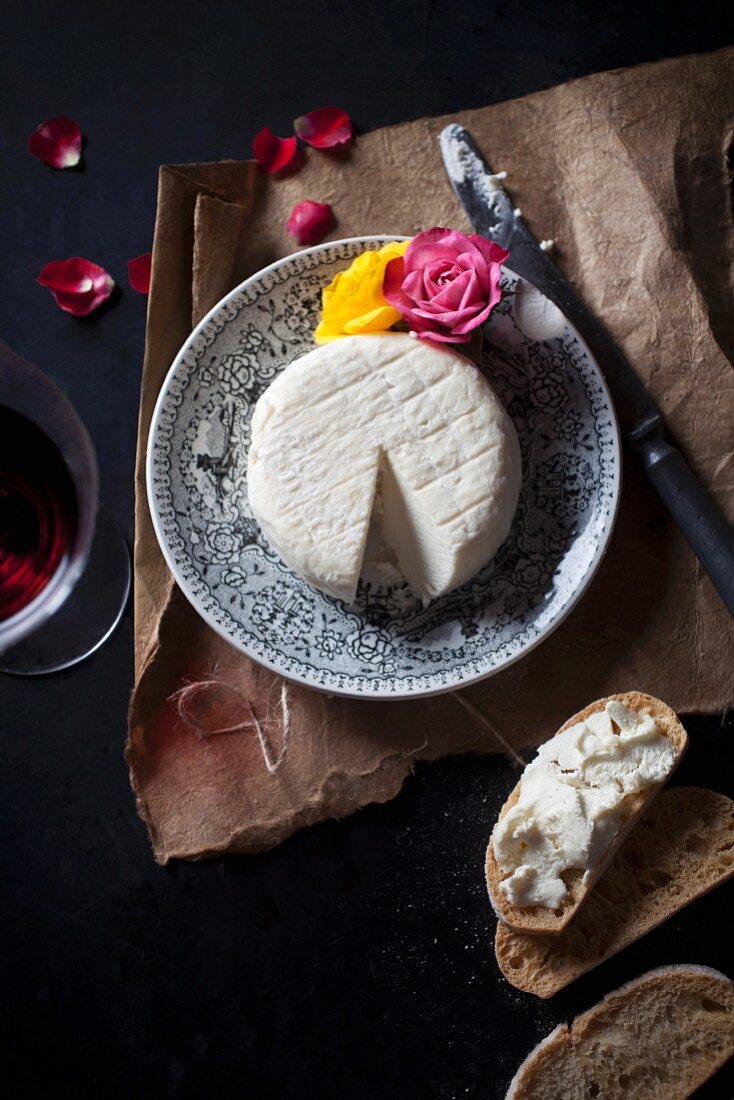 Sliced cheese with bread and wine