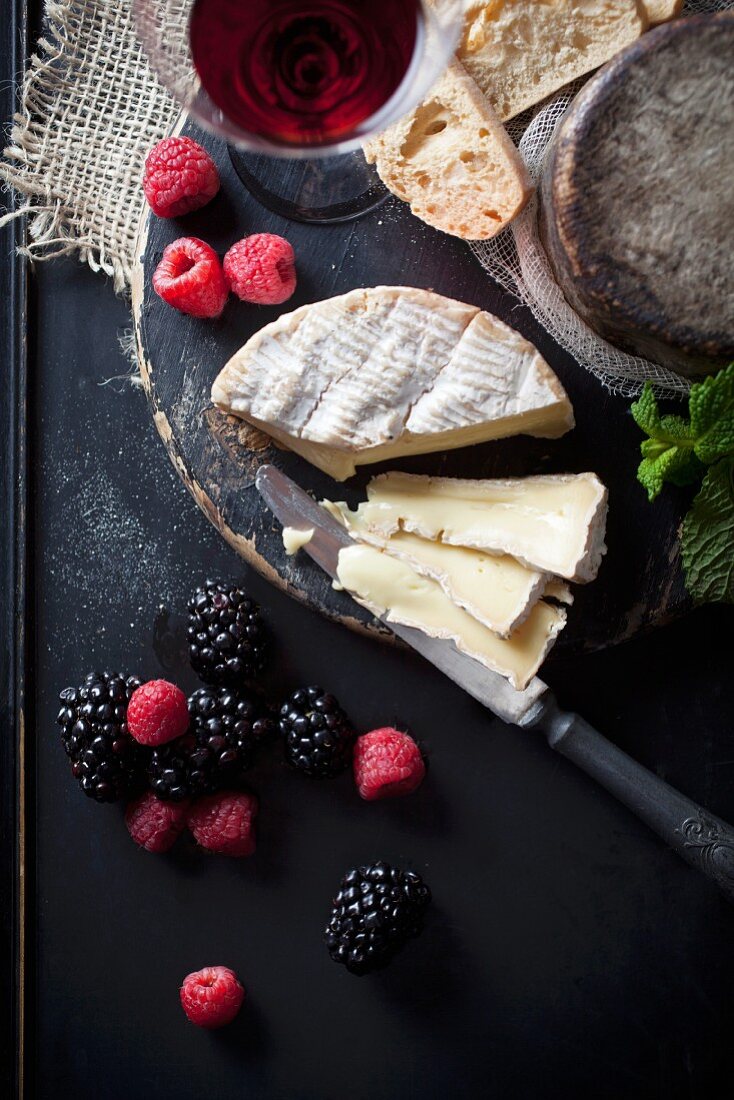 Camembert with fresh berries, bread and wine