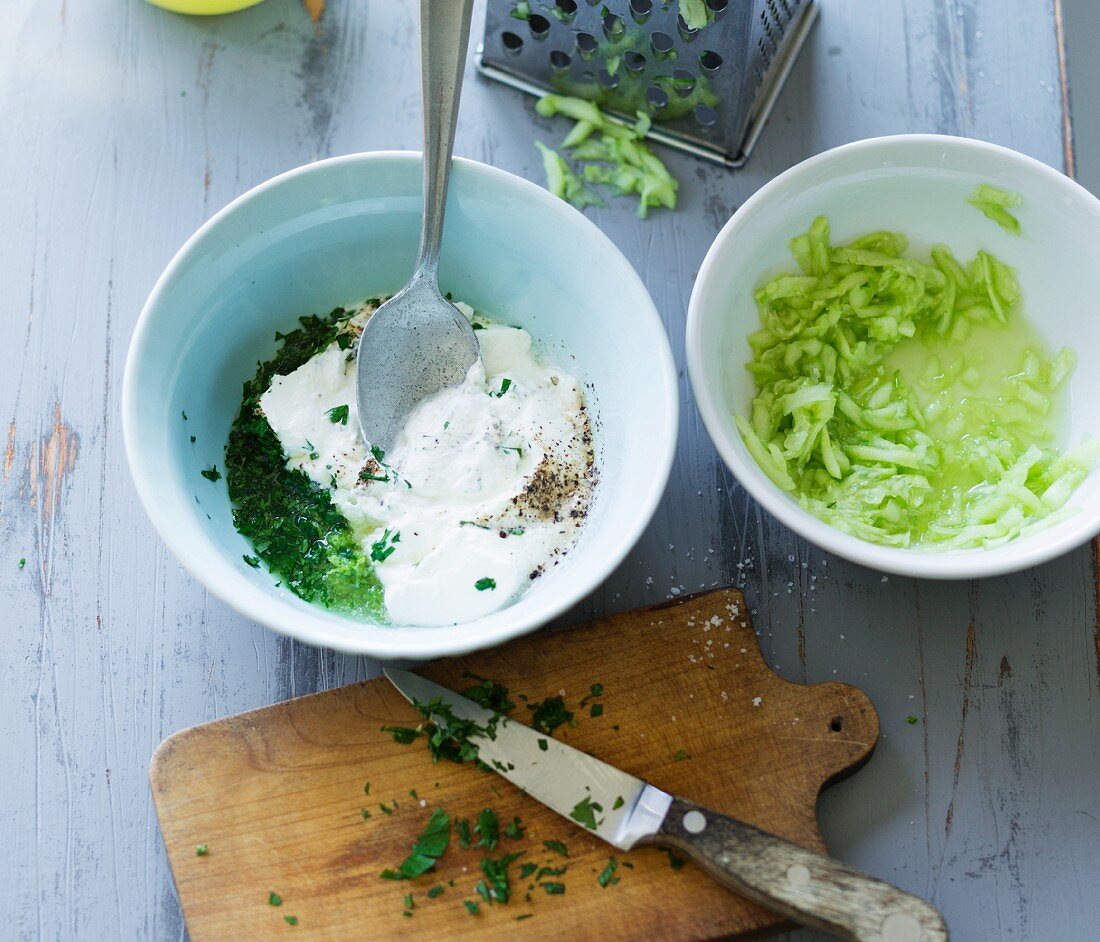 A yogurt dip with grated cucumber and lime being made