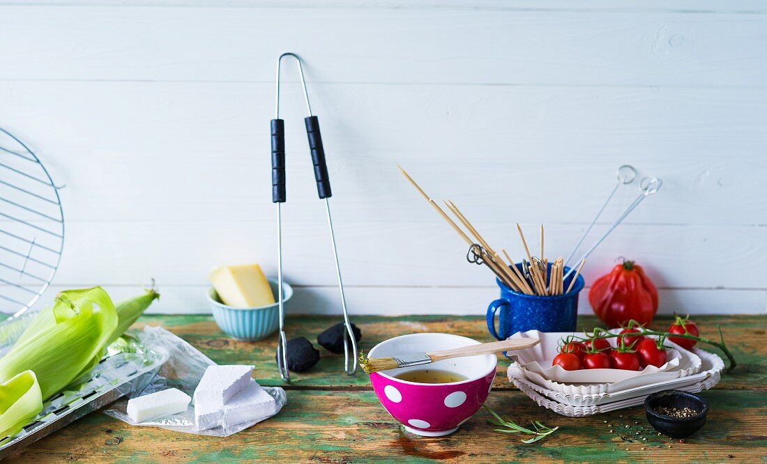 An arrangement of barbecuing utensils and ingredients