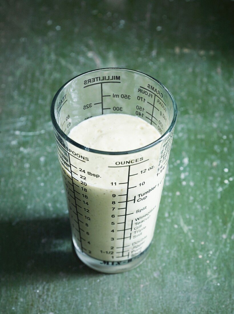 An avocado smoothie in a measuring jug