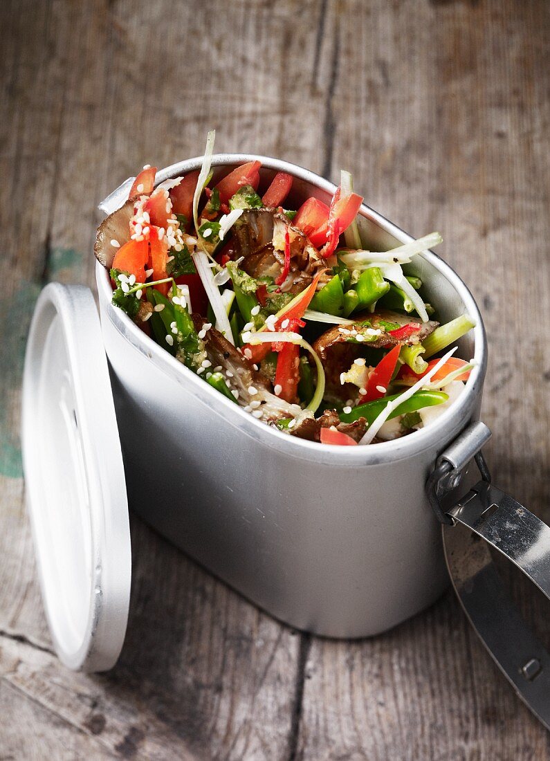 A vegetable salad with peppers, mushrooms and sesame seeds