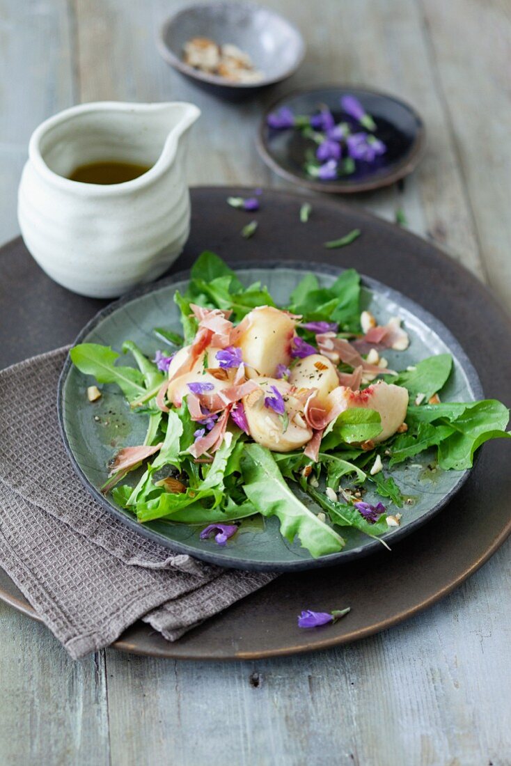 A dandelion leaf salad with peaches and ham