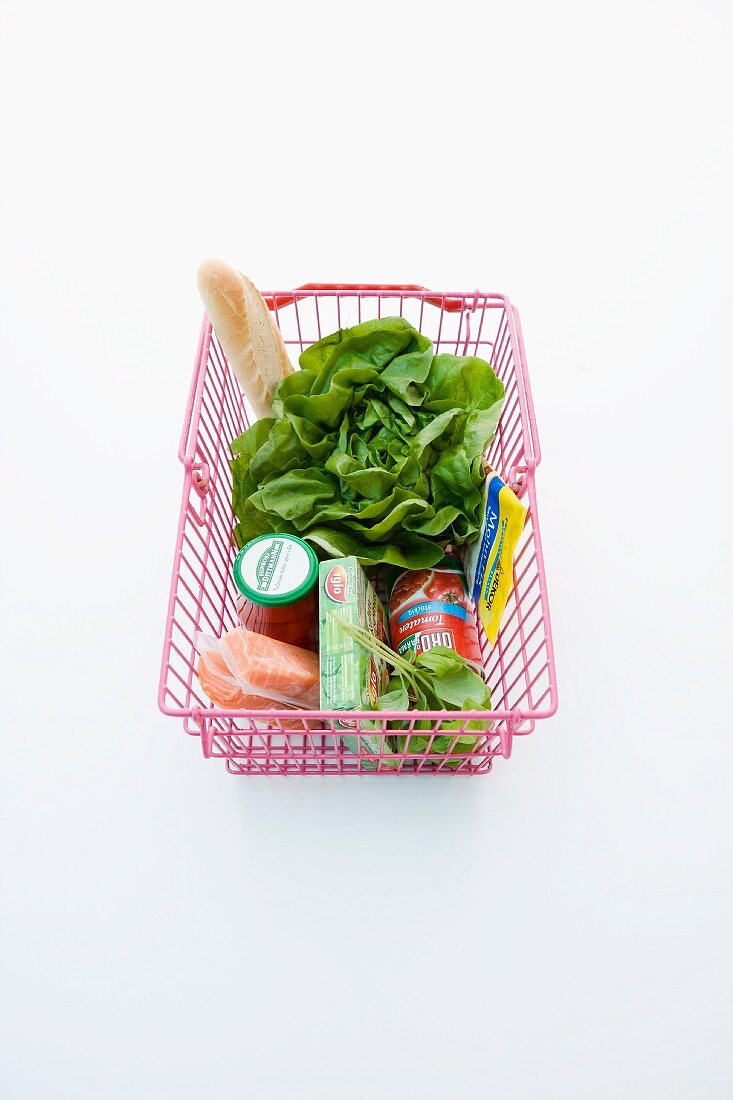 Salmon fillet, tinned tomatoes and lettuce in a shopping basket