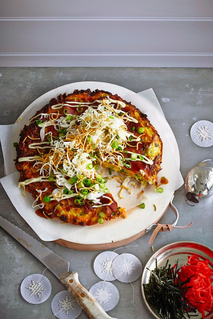 A Japanese omelette with sliced cabbage, daikon and fried noodles