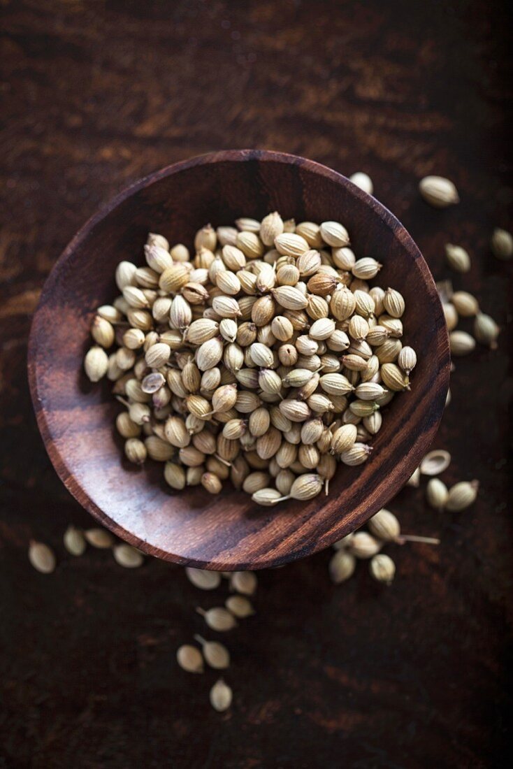 Coriander seeds in a wooden bowl