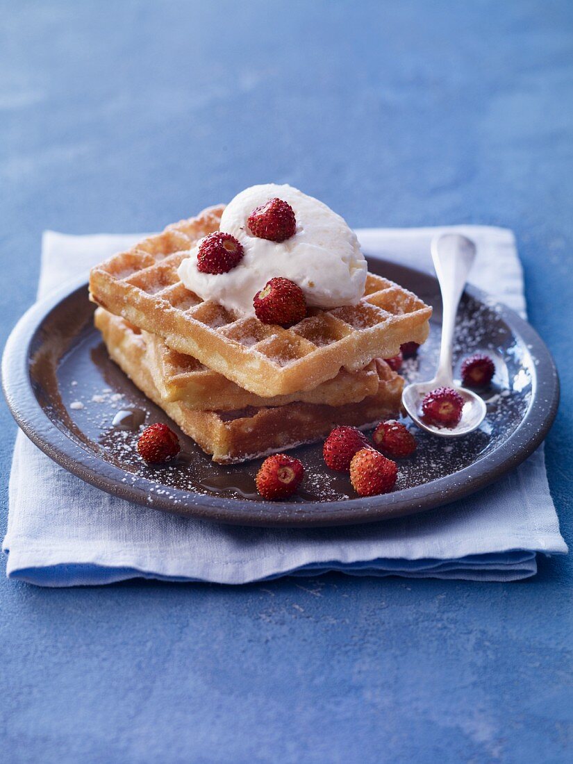 Waffles with wild strawberries and ice cream