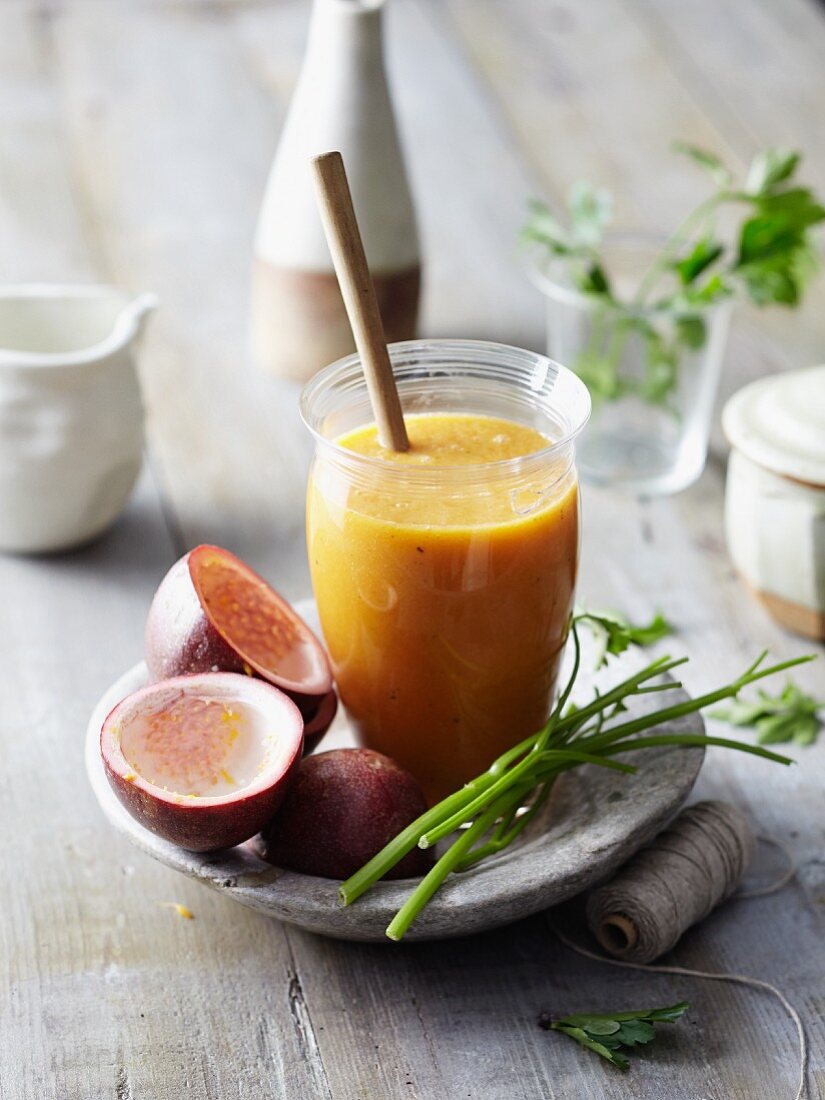 A papaya smoothie served with passion fruit and parsley