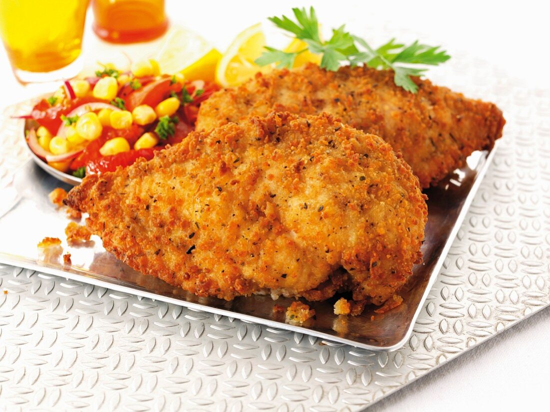 Breaded chicken breast with a tomato and sweetcorn salad