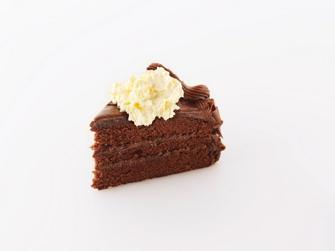 A Slice of Rich Chocolate Layer Cake with Whipped Cream