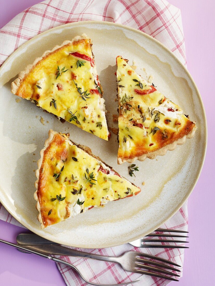 Three slices of herb quiche with bacon