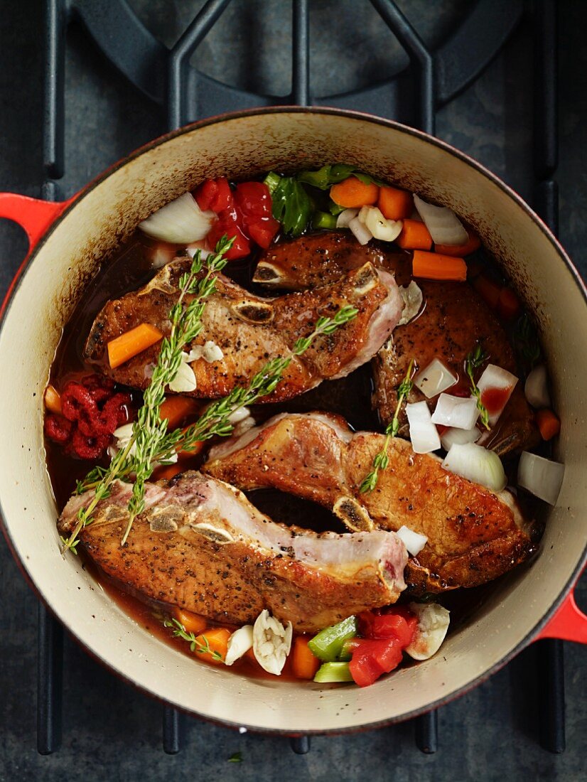Pork chops with vegetables in a braising dish