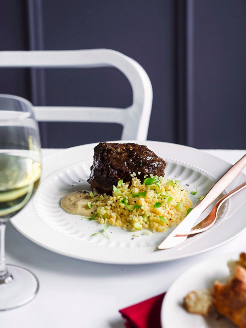Braised beef cheeks with a bulgur salad and an anchovy sauce