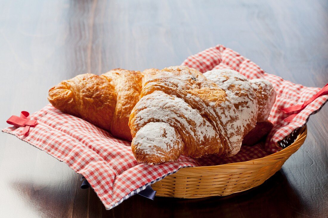 Chocolate and cinnamon croissants in a bread basket
