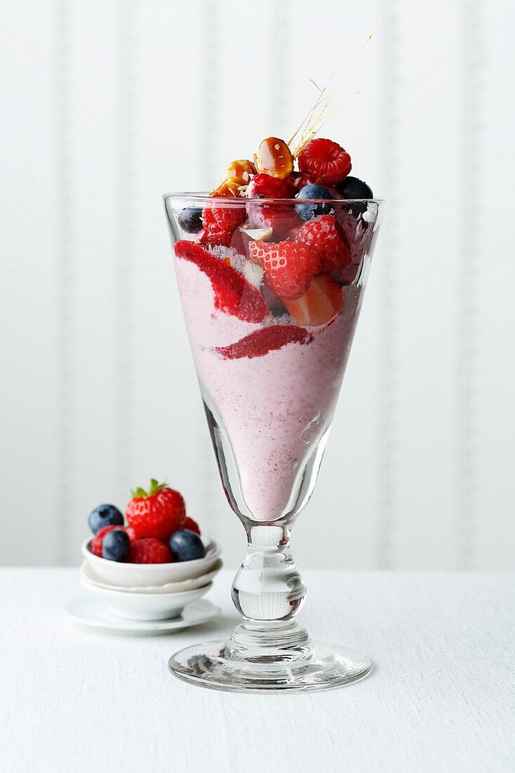Frozen oat yogurt with berries and macadamia brittle