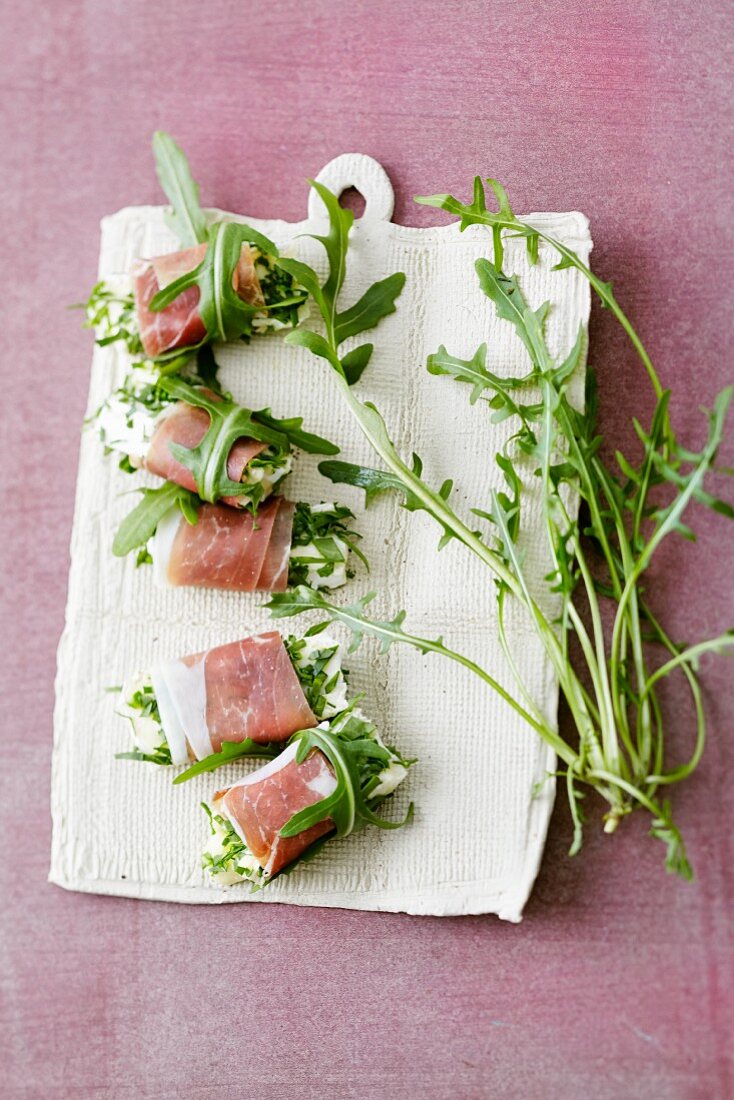 Unpasteurized cheese with rocket wrapped in ham