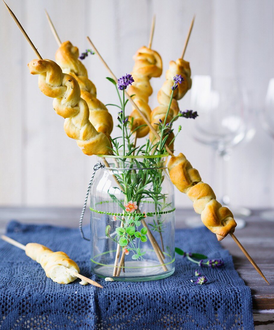 Plaited bread on wooden sticks