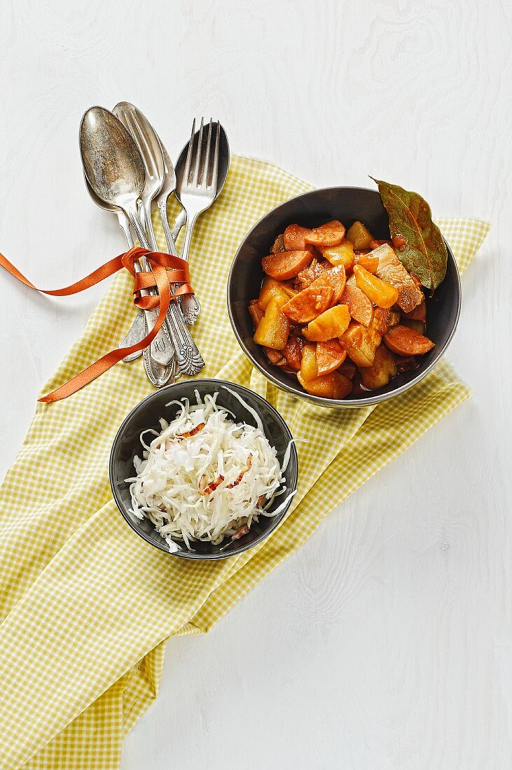 Warm cabbage salad with bacon and a potato and sausage goulash with pork belly