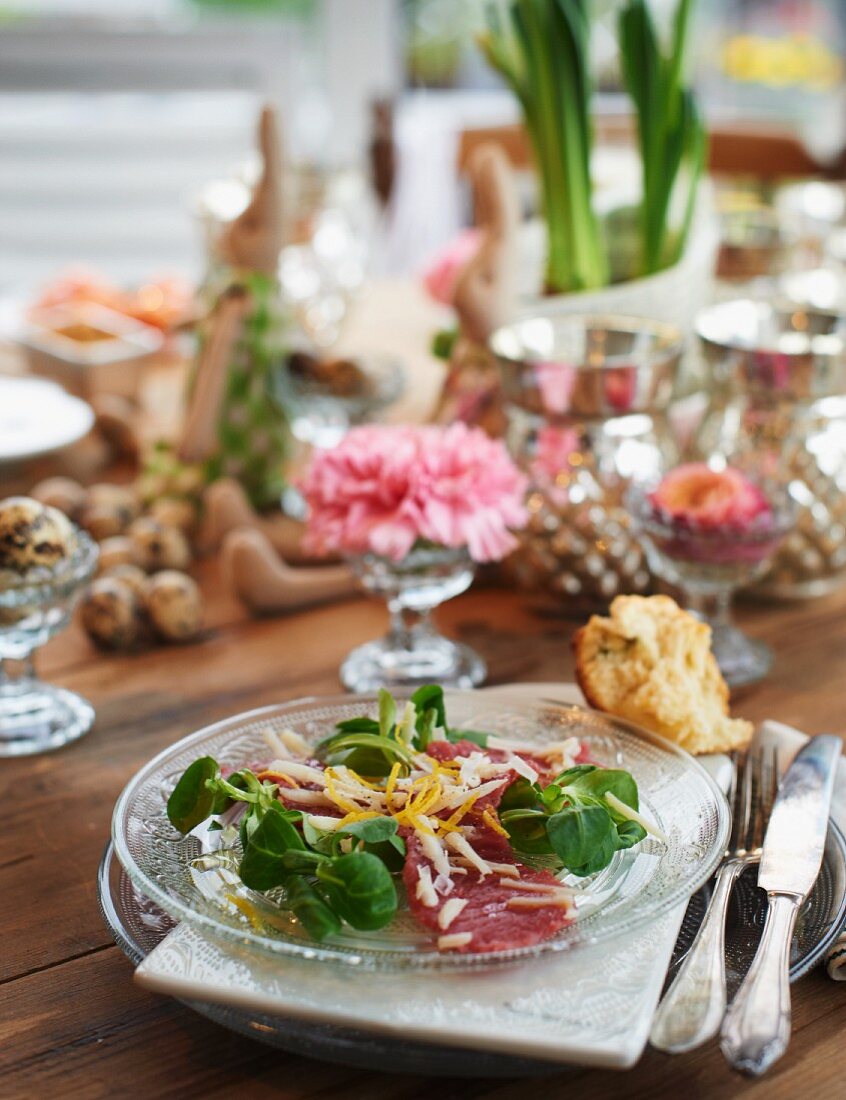 Lamb carpaccio with lamb's lettuce, lemon sauce and Parmesan cheese