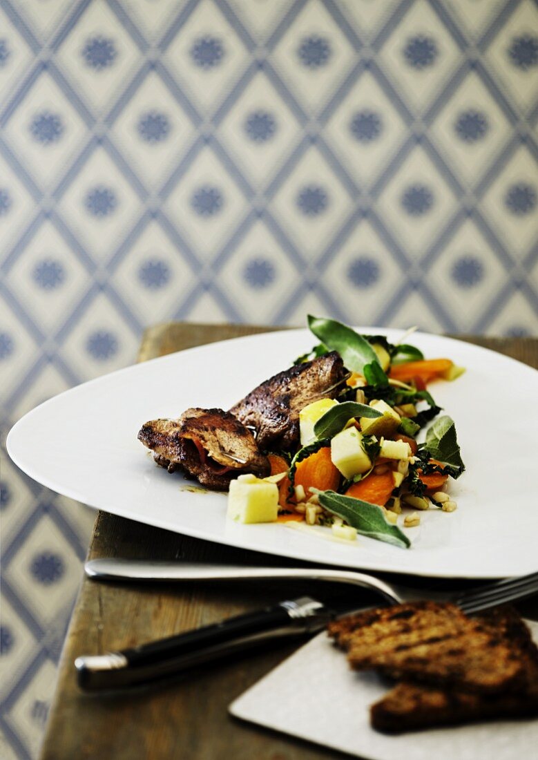 A small grilled skewer with a vegetable and herb salad