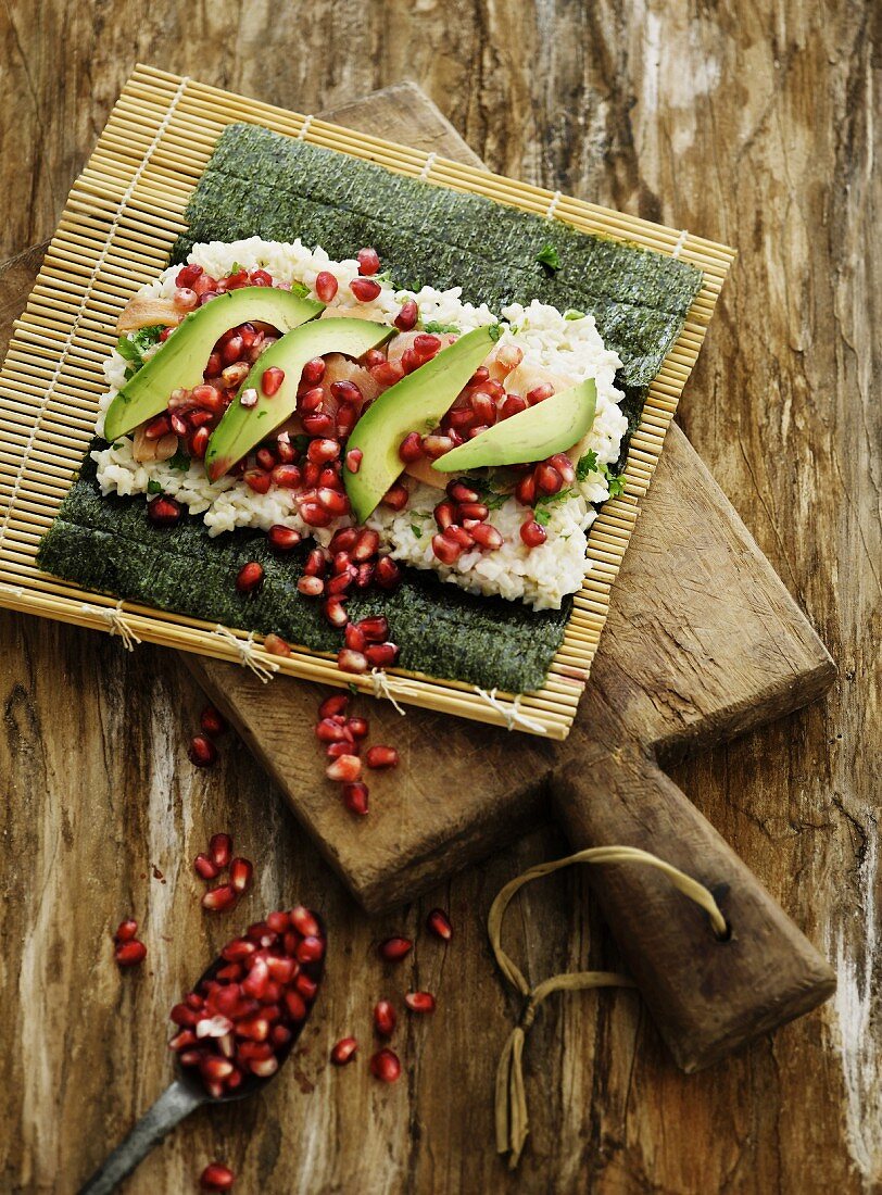 Sushi with pomegranate seeds, avocado and salmon