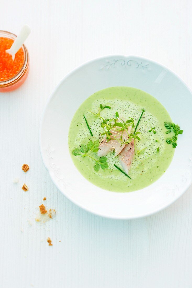 Creamy soup with herbs and smoked trout