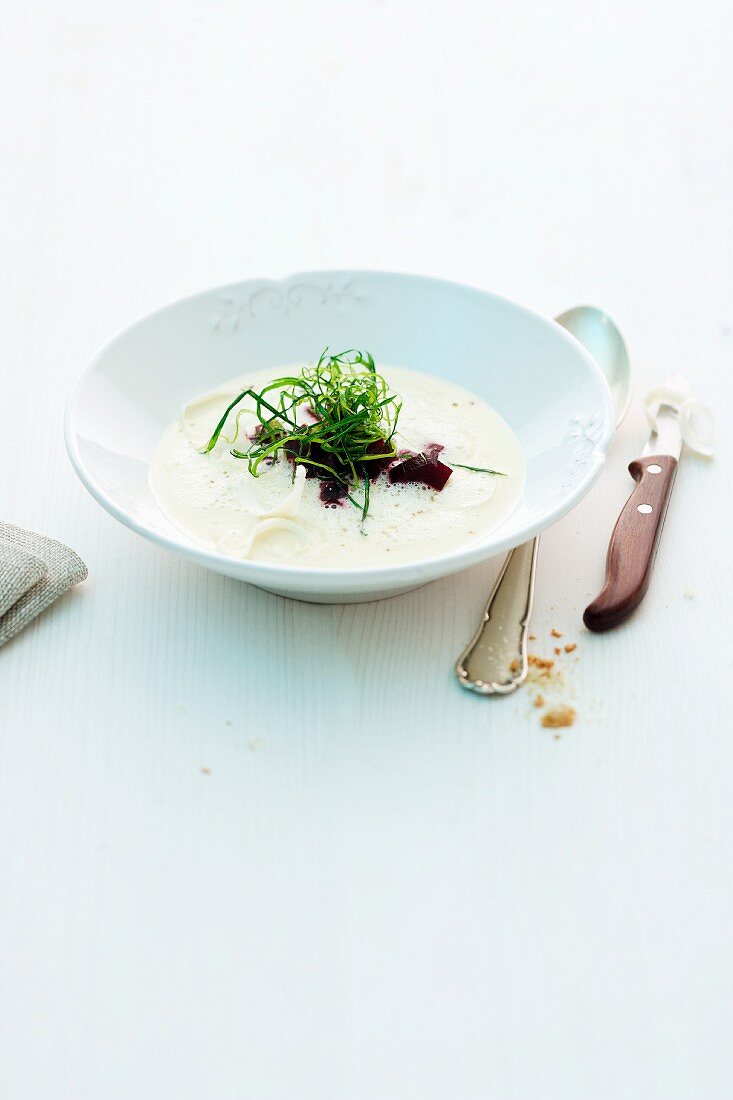 Creamy soup with horseradish, beetroot and fried leek greens