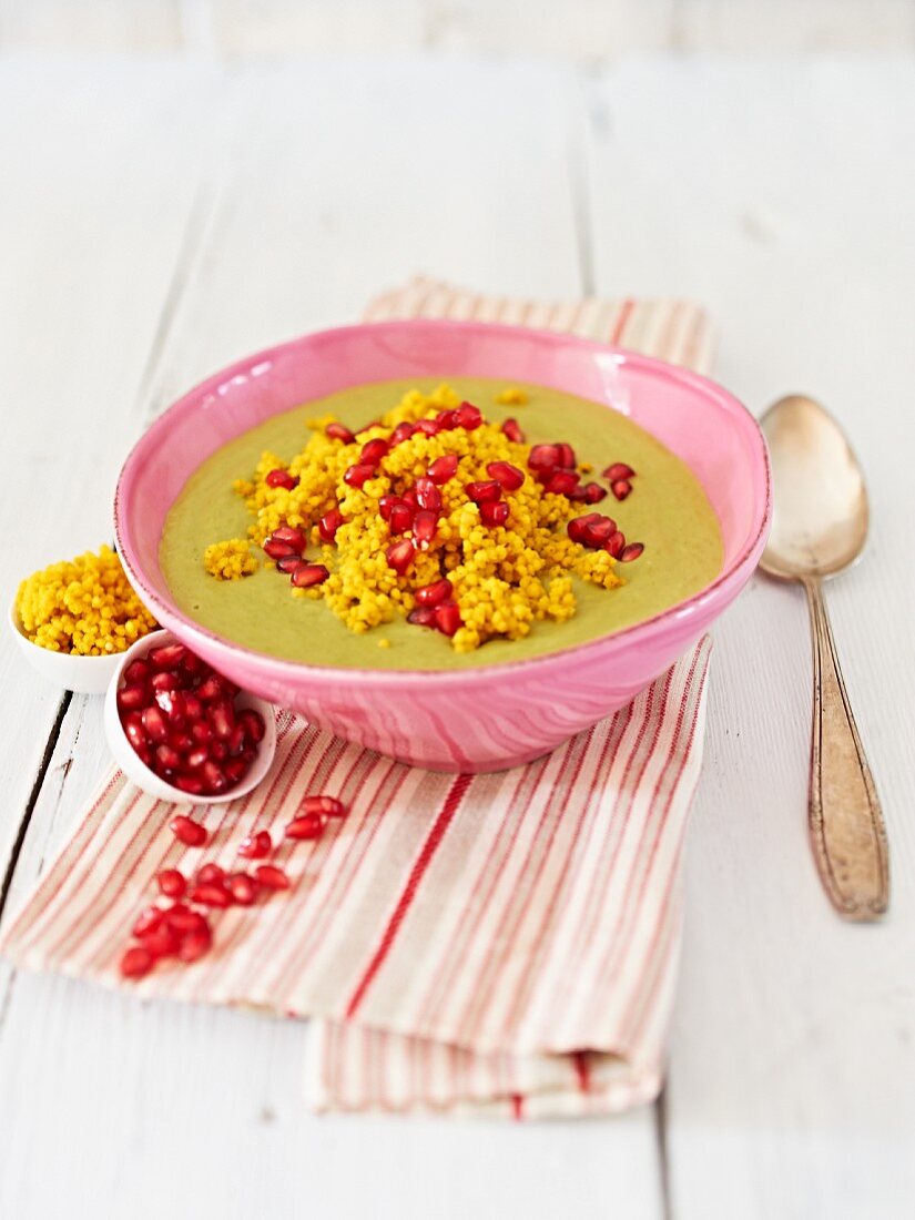 Pea and coconut milk soup with millet and pomegranate seeds
