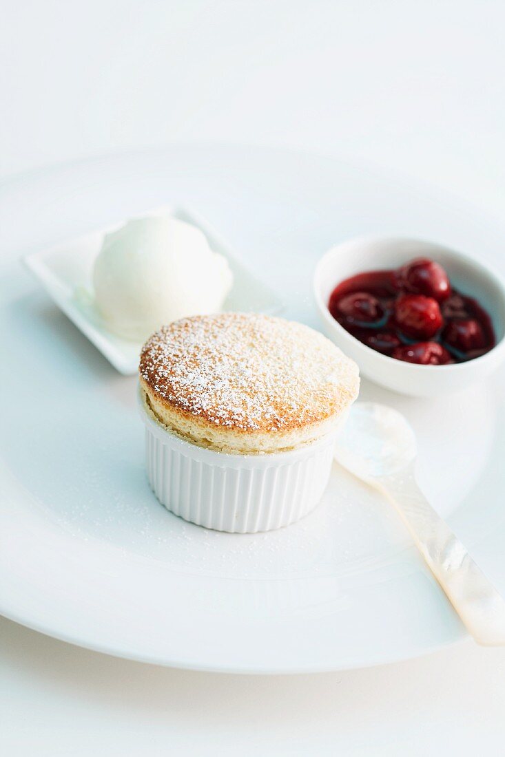 Banana souffle with ice cream and cherry sauce