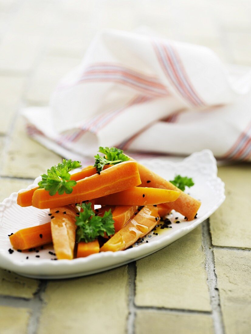 Carrots cooked in orange juice with parsley and black sesame seeds
