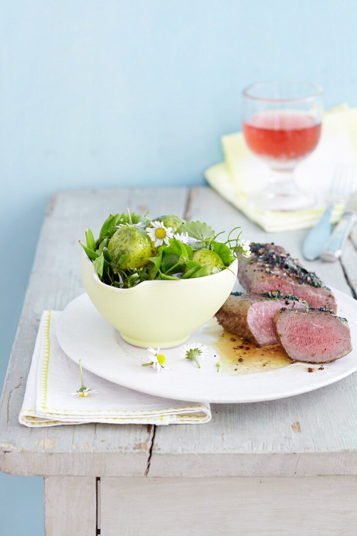 Lamb fillet and potato salad with wild herbs