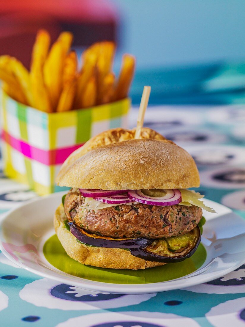 A lamb burger with aubergines and onions