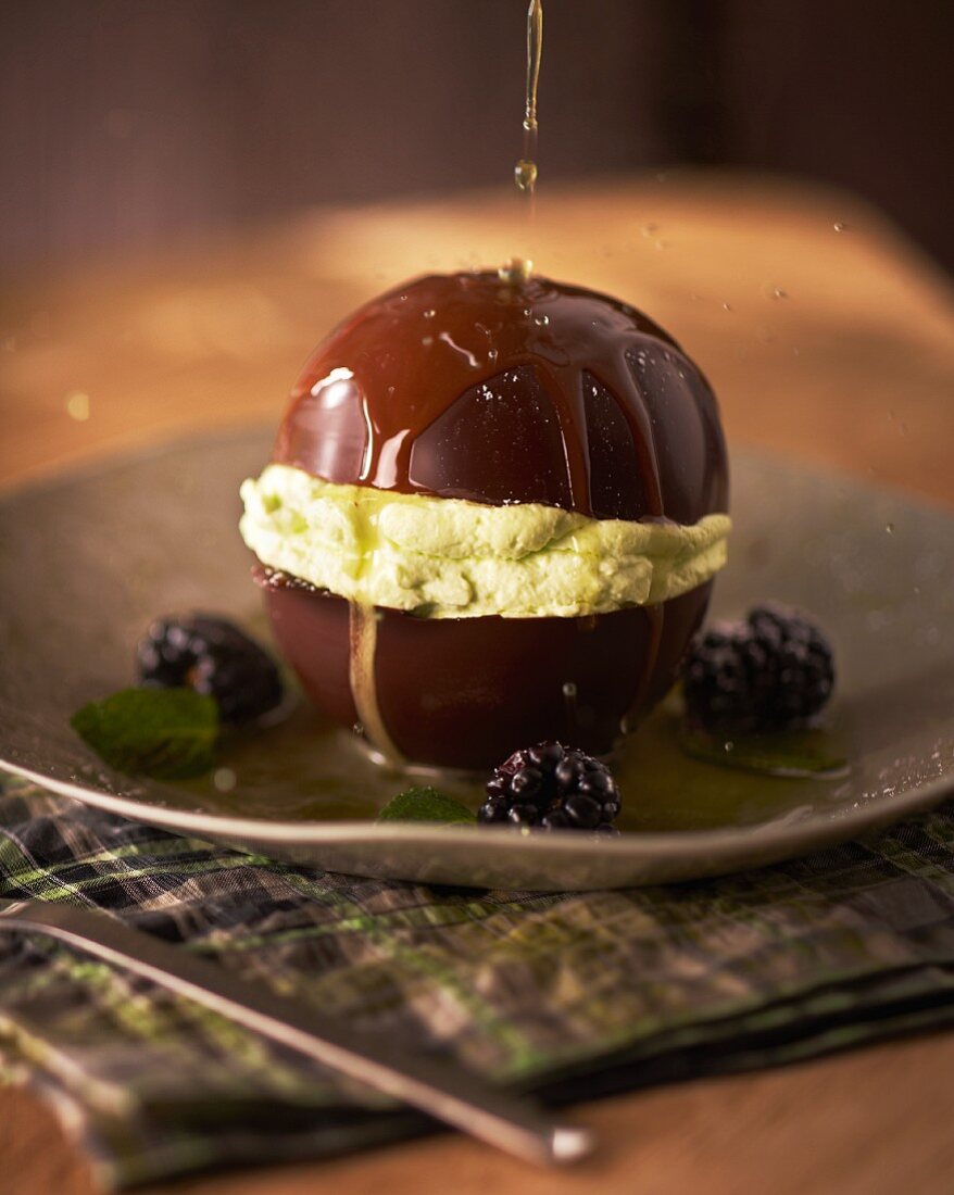 A chocolate ball filled with green Chartreuse cream