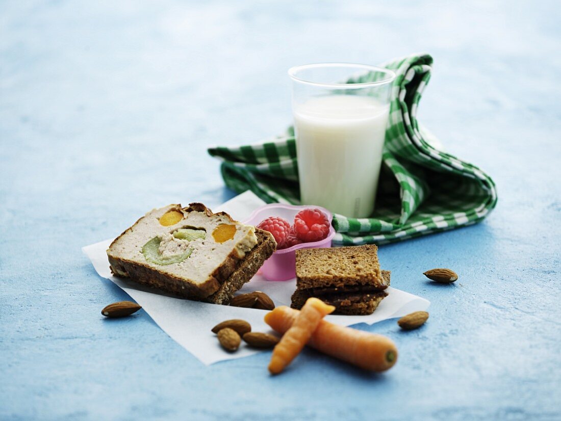 Vegetable terrine, bread, carrots, almonds, raspberries and milk for lunch