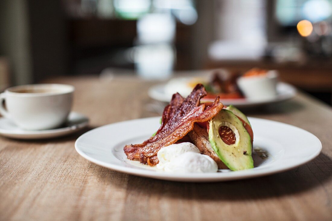 Toast with bacon, poached egg and avocado