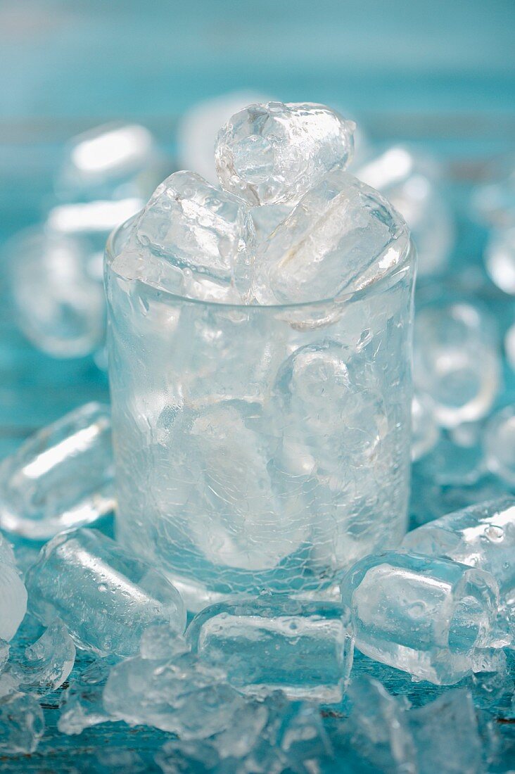 Ice cubes in a glass and around it
